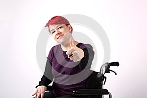 Optimistic Girl in wheelchair with thumbs up