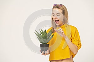 Optimistic lady holding a potted herb