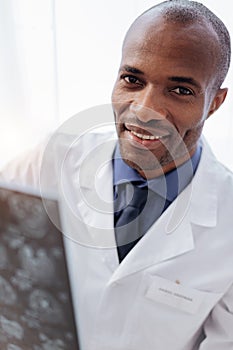 Optimistic male doctor perusing brain imaging