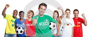 Optimistic mexican soccer supporter with ball and fans from other countries