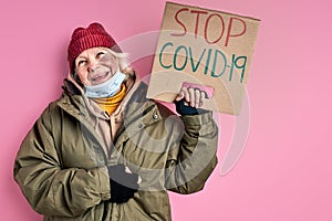optimistic poor homeless woman in dirty wear wants coronavirus to be stopped
