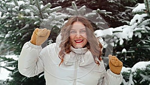 Optimistic smile woman in winter warm clothing dancing outside. Happy attractive lady dance, have fun and enjoy quality