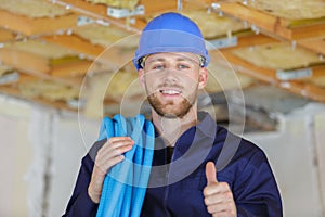 optimistic worker builder man shows thumb up