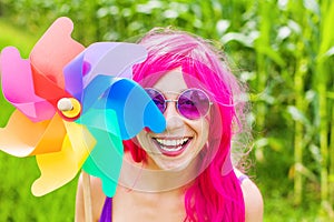 Optimistic young woman wearing pink wig