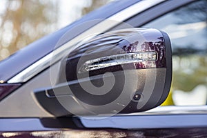 Option of a 3d cam monitor system in a modern car. close-up side view rearview mirror of modern car with round view camera of