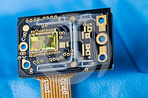 Optoelectronic image sensor of optical laser computer mouse on a blue background