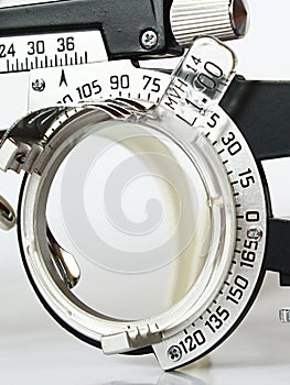 Optometric trial frame detail of left eye with inserted progressive lens.
