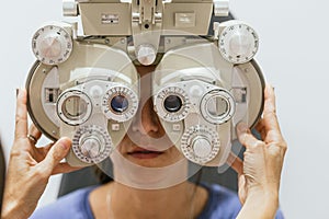 Optometrist adjusting trial frame for eye examination
