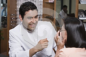 Optometrist assisting patient in choosing glasses