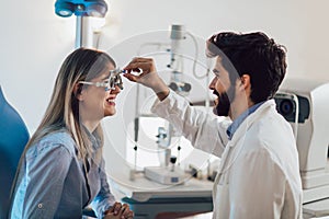 Optometrist checking patient eyesight and vision correction