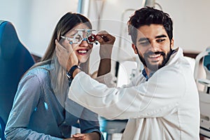 Optometrist checking patient eyesight and vision correction