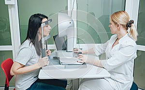 Optometrist is doing corneal topography. Corneal exam. Ophthalmology clinic