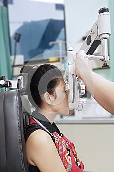 Optometrist doing a sight test her patient