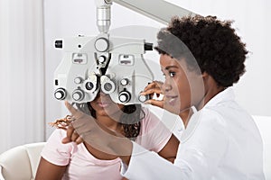 Optometrist Doing Sight Testing For Patient