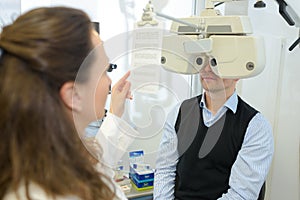optometrist doing sight testing for patient