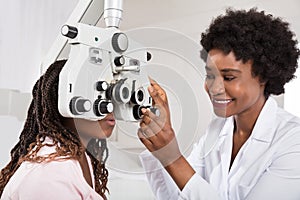 Optometrist Doing Sight Testing For Patient photo