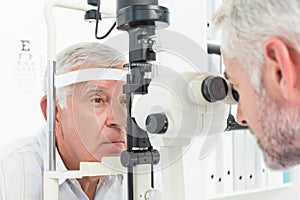 Optometrist doing sight testing for senior patient