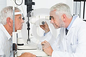 Optometrist doing sight testing for senior patient