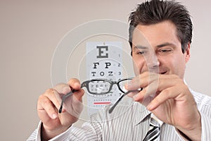 Optometrist examining eye glasses