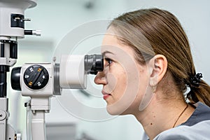 Optometrist examining the eyes of a male patient in a modern ophthalmology clinic. Eye doctor with man patient during an