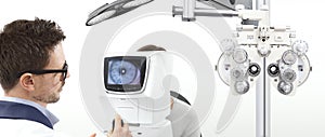 Optometrist examining eyesight patient in optician office