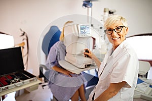 Optometrist examining patient in modern ophthalmology clinic