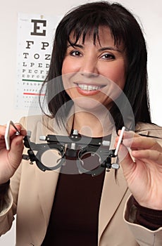 Optometrist holding trial frames