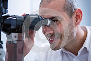 Optometrist looking through biomicroscope
