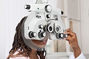 Optometrist`s Hand Adjusting Phoropter