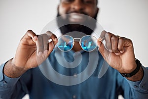 Optometry, closeup and a black man showing glasses for healthcare, consulting or an exam. Lens, happy and an African