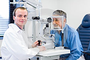 Optometry concept - man having her eyes examined