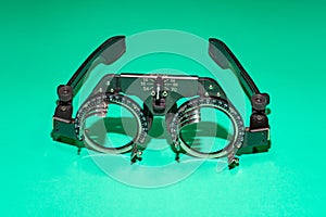 Optometry optics test glasses on a green table.