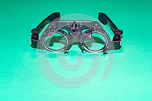 Optometry optics test glasses on a green table.