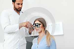 Optometry Test. Eye Doctor Checking Woman Eyesight At Clinic