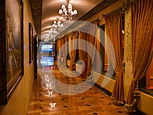 Opulent corridor with marble floor and curtains