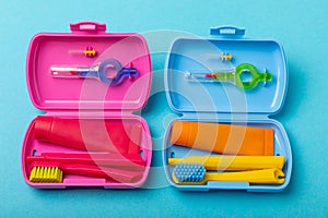 Oral care. Set of toothbrushes,toothpaste and brush on pink background.