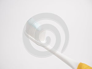 Oral concept. Close up yellow Toothbrush With blue Toothpaste.