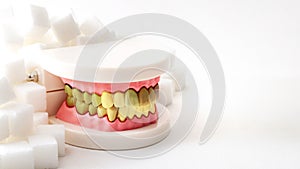 Oral health, tooth decay and cavities and sugary foods destroy the dental enamel concept with plastic medical model of cavity