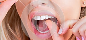 Oral hygiene and health care. Smiling women use dental floss white healthy teeth. Dental flush - woman flossing teeth