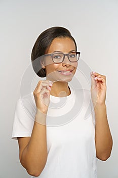 Daily oral hygiene routine: young woman hold dental floss for cleaning teeth from food after meal