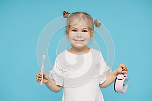 Oral hygiene. Time to brush your teeth. Little child girl brushing her teeth with a toothbrush