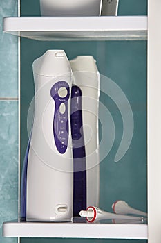 Oral irrigator or water flosser on bathroom vanity shelf