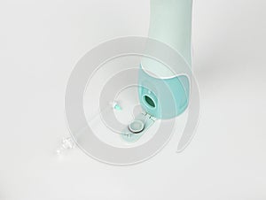 oral irrigator on a white background, close-up, isolated, back side with brush for braces