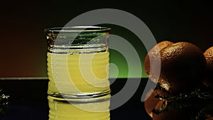 Orange alcohol cocktail in a glass on colorful wall background. Stock clip. Cold refreshing drink and a bar counter with