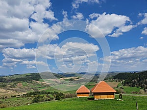 Orange alcoves in the meadow with mountains and green meadow in the background photo