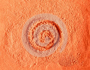 Orange alginate mask powder pumpkin cream, turmeric body scrub texture close up. Abstract background