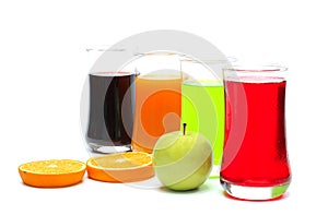 Orange , apple , grape and strawberry juice in glass , ripe orange and ripe green apple