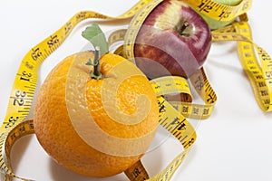 Orange apple and measurement tape