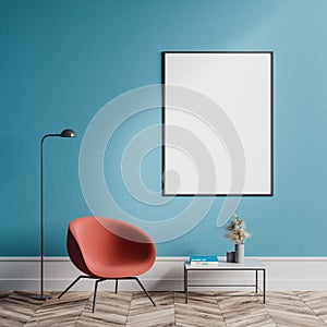 Orange armchair in blue living room with poster