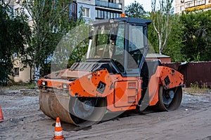 Orange asphalt paver in Ukraine.  The new road construction